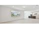Spacious living room featuring a bright window and an adjacent kitchen area at 37202 Clinch Cir, Zephyrhills, FL 33540