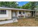 Inviting front porch with rocking chairs, hanging swing, and shuttered windows; a perfect spot to relax at 3753 Hollow Oak Pl, Land O Lakes, FL 34639