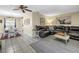 Inviting living room that flows to dining, featuring an oversized leather couch and decor at 3753 Hollow Oak Pl, Land O Lakes, FL 34639