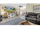 Bright living room with a large TV and decor that flows to the dining room at 3753 Hollow Oak Pl, Land O Lakes, FL 34639