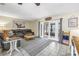 Comfortable living room with a large sofa and sliding glass doors to the sunroom at 3753 Hollow Oak Pl, Land O Lakes, FL 34639