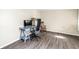 A bright and spacious office featuring hardwood floors, desk, and rocking chair at 3753 Hollow Oak Pl, Land O Lakes, FL 34639