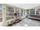 Bright sunroom with tiled floors, multiple windows and view of the backyard playset at 3753 Hollow Oak Pl, Land O Lakes, FL 34639