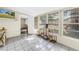 Sunroom with view to backyard featuring a treehouse, string lights and tile flooring at 3753 Hollow Oak Pl, Land O Lakes, FL 34639