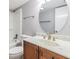 Bathroom features white marble counters, wooden vanity, and shower-tub combination at 4002 Cypress Ct # 4002, Tampa, FL 33618