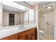 Bathroom with floral wallpaper, large mirror, and shower at 4002 Cypress Ct # 4002, Tampa, FL 33618
