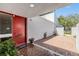 Cozy front porch with brick tiling, red front door, and potted plants creating a welcoming entrance at 4002 Cypress Ct # 4002, Tampa, FL 33618