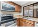 Well-lit kitchen features stainless appliances, granite countertops and a garden window at 4002 Cypress Ct # 4002, Tampa, FL 33618