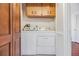 Convenient laundry area includes washer, dryer, and built-in storage cabinets at 4002 Cypress Ct # 4002, Tampa, FL 33618