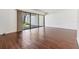 Clean living room featuring wood-look tile floors, large sliding glass door and view of outside at 4002 Cypress Ct # 4002, Tampa, FL 33618