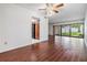 Open living area with sleek floors, neutral walls, ceiling fan and access to kitchen and backyard at 4002 Cypress Ct # 4002, Tampa, FL 33618