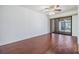 Modern living room showcasing wood-look tile floors, ceiling fan, and access to a private patio at 4002 Cypress Ct # 4002, Tampa, FL 33618