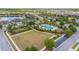 Aerial view showcases lush greenery and a pristine community pool, creating an inviting and picturesque neighborhood at 4220 Barletta Ct, Wesley Chapel, FL 33543