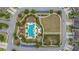 An aerial view of community pool area with meticulously landscaped green space, parking, and neatly manicured hedges at 4220 Barletta Ct, Wesley Chapel, FL 33543