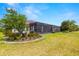 Screened-in patio and lush landscaping in the backyard, perfect for outdoor living at 4220 Barletta Ct, Wesley Chapel, FL 33543