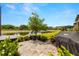 Backyard with a beautiful lake view and deck with a grill at 4220 Barletta Ct, Wesley Chapel, FL 33543