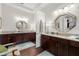 Bathroom featuring dual vanities, custom cabinets and modern lighting fixtures at 4220 Barletta Ct, Wesley Chapel, FL 33543