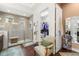 Elegant bathroom featuring a tiled shower, walk in closet, and a comfortable chair at 4220 Barletta Ct, Wesley Chapel, FL 33543