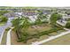Beautiful aerial view of community park with walking path, mature trees, manicured landscaping and neighborhood homes at 4220 Barletta Ct, Wesley Chapel, FL 33543
