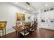 Elegant dining room with a large table, stylish chandelier, and access to the kitchen, ideal for hosting gatherings at 4220 Barletta Ct, Wesley Chapel, FL 33543