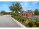 Community entrance with brick signage and beautiful flower beds at 4220 Barletta Ct, Wesley Chapel, FL 33543