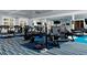 Well-equipped gym with treadmills, ellipticals, weight machines, and a striped blue carpet at 4220 Barletta Ct, Wesley Chapel, FL 33543