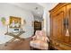 Elegant hallway featuring wood floors, decorative lighting, and an antique armoire at 4220 Barletta Ct, Wesley Chapel, FL 33543