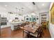 Open-concept kitchen features a large island, white cabinetry, and elegant lighting fixtures at 4220 Barletta Ct, Wesley Chapel, FL 33543