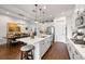 Spacious kitchen with white cabinets, stainless appliances, a center island with seating, and an adjacent dining area at 4220 Barletta Ct, Wesley Chapel, FL 33543