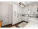 Bright laundry room featuring white cabinetry, granite counters, and updated fixtures at 4220 Barletta Ct, Wesley Chapel, FL 33543