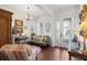 Cozy living room featuring an ornate door, hardwood floors, and traditional decor at 4220 Barletta Ct, Wesley Chapel, FL 33543