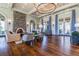 Relaxing living room featuring a fireplace, hardwood floors, blue curtains and a chandelier at 4220 Barletta Ct, Wesley Chapel, FL 33543