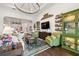 Comfortable living room with a large TV, stylish decor, and an open layout flowing into the kitchen at 4220 Barletta Ct, Wesley Chapel, FL 33543