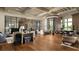 Inviting lobby featuring a chandelier, hardwood floors, blue curtains, and a bar area at 4220 Barletta Ct, Wesley Chapel, FL 33543