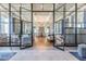 Grand entrance lobby featuring glass doors, a chandelier, and wood floors at 4220 Barletta Ct, Wesley Chapel, FL 33543