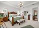 Charming bedroom with decorative chandelier, large bed and access to ensuite bathroom at 4220 Barletta Ct, Wesley Chapel, FL 33543