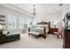 Spacious bedroom featuring natural light, a decorative chandelier, and a cozy sitting area at 4220 Barletta Ct, Wesley Chapel, FL 33543