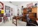 Cozy home office featuring classic wooden furniture, aviation memorabilia, and ample natural light at 4220 Barletta Ct, Wesley Chapel, FL 33543