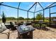 Enclosed patio with comfortable seating, dining area, and scenic lake view at 4220 Barletta Ct, Wesley Chapel, FL 33543