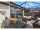Covered patio and outdoor dining area, perfect for entertaining, with lovely landscape at 4220 Barletta Ct, Wesley Chapel, FL 33543