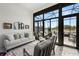 Light-filled sunroom with a seating area and views of the outdoor patio and beautiful waterfront landscape at 4220 Barletta Ct, Wesley Chapel, FL 33543