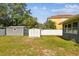 Wide backyard shot featuring two storage sheds and privacy fence at 4610 W Mcelroy Ave, Tampa, FL 33611