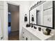 Bathroom with a white vanity, black fixtures, and plenty of natural light at 4610 W Mcelroy Ave, Tampa, FL 33611