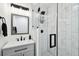 Stylish bathroom features a glass-enclosed shower with black fixtures and modern fixtures at 4610 W Mcelroy Ave, Tampa, FL 33611