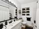 Modern bathroom featuring a white vanity, black fixtures, and decorative black accents at 4610 W Mcelroy Ave, Tampa, FL 33611