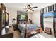 Well-lit bedroom features a four-poster bed and natural light from the two windows at 4610 W Mcelroy Ave, Tampa, FL 33611
