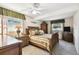 Cozy bedroom with a ceiling fan, wood furnishings, and plenty of natural light at 4610 W Mcelroy Ave, Tampa, FL 33611