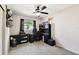 Bedroom with neutral carpet, ceiling fan and functional furniture pieces at 4610 W Mcelroy Ave, Tampa, FL 33611