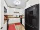 Bright kitchen features white cabinets, granite countertops, and modern black appliances at 4610 W Mcelroy Ave, Tampa, FL 33611