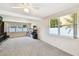 Bright living room with neutral carpet and large windows offering ample natural light at 4610 W Mcelroy Ave, Tampa, FL 33611